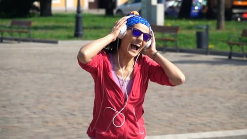 Young, Happy Woman Listening To Music In The City, Slow Motion
