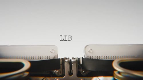 Old mechanical typewriter typing Library in a close-up view.