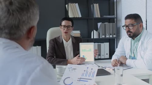 Medical Professionals Discussing Data in Modern Office