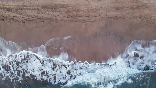 Aerial View of Beach with Views of Waves and Water Crashing on to Sandy Beach