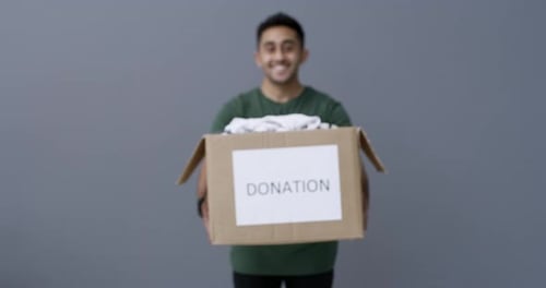 Young Adult Holding a Donation Box