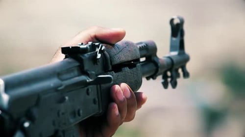 An army soldier holds a gun in his hand (AKM)