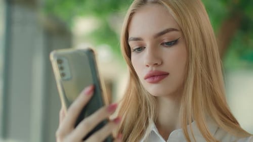 Young Woman Using Mobile Phone in City
