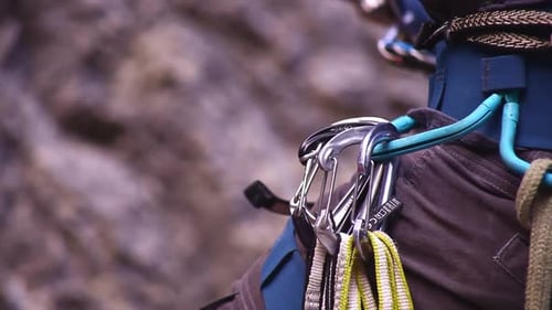 Climber belaying and his tools close up