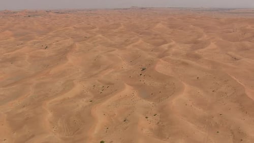 Desert dunes flyoverin forward motion with horizon and slight tilt down