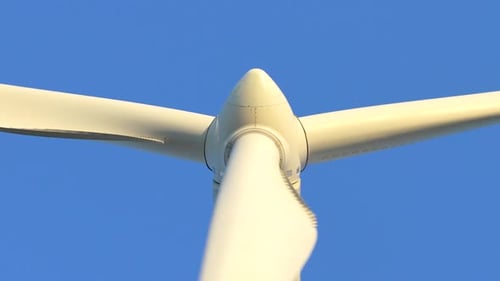 White wind turbine blades rotating generating renewable energy