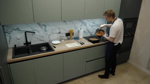 Adult Cooking Food in Modern Kitchen
