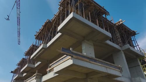 Vídeo aéreo: Perspectiva aérea de grúas y tareas de metal en una obra de construcción muy transitada