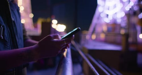 Looped Shot of Woman Scroll on Phone at Night