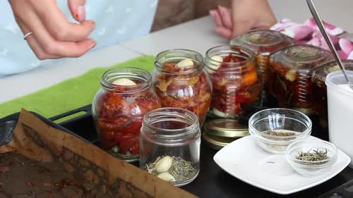 Filling Jars with Sun-Dried Tomatoes and Garlic