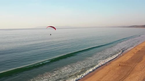 Aerial View of Paraglider Flying Over Sea at Beach on Summer Vacation