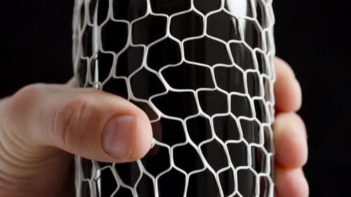Protection for an expensive wine bottle in the form of a white soft net. Mesh Bottle Sleeves.