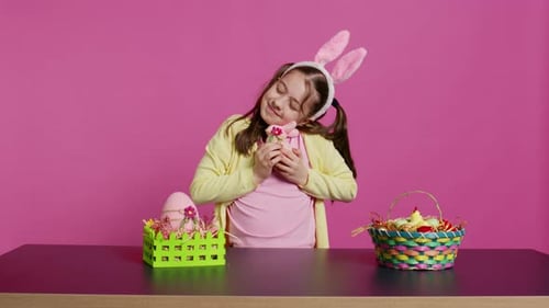 Cheerful Smiling Girl Hugging Her Stuffed Rabbit Toy and Egg