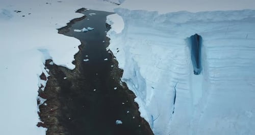 Aerial Panorama Towering High Glacier Over Ocean