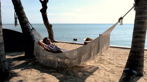 Couple Men and Women on a Tropical White Beach in a Hammock in Thailand Hua Hin