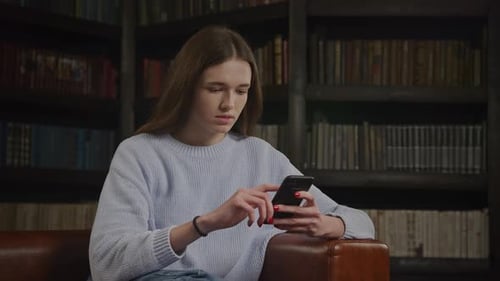 Young Woman Reading Online on Smart Phone