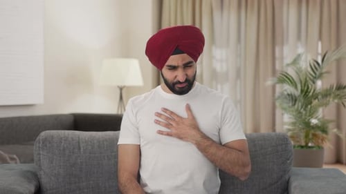 Man with Stomach Pain on Couch