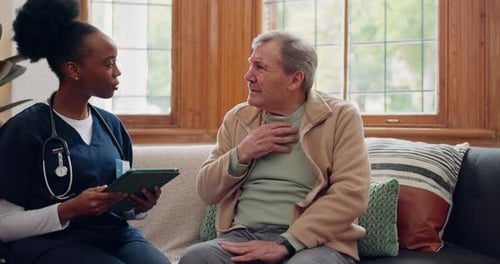 Doctor Consults with Senior Man at Home