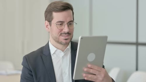 Man Having a Video Call on Tablet Indoors