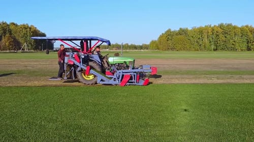A Beautiful Aerial View Showcasing Agricultural Machinery in Action Across Vast Fields