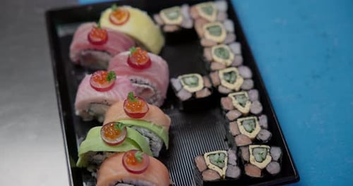 Sushi Rolls with Tuna Salmon and Mango on a Plastic Delivery Tray