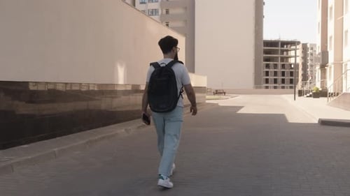 Man Walking Down City Street