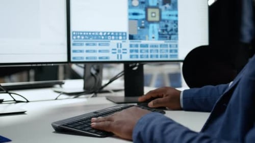 Close Up of Technician in Semiconductors Factory Office Analyzing PCBs
