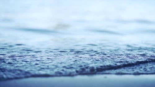 Close Up of Water Breaking on the Shore at New Chums Beach New Zealand