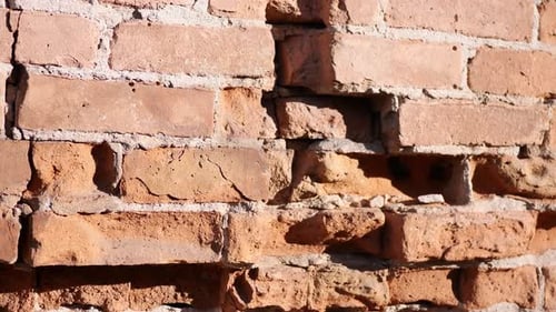Old distressed building with red and white bricks that have cracked from recent earthquake damage, i