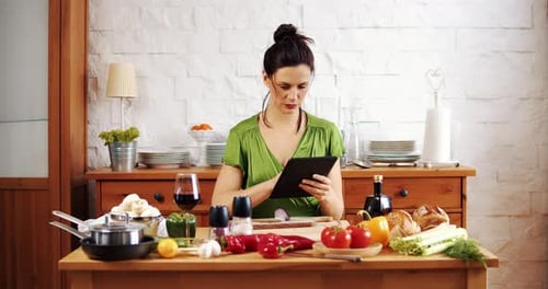 Beautiful Woman Checks the Recipe for Spring Food on the Tablet
