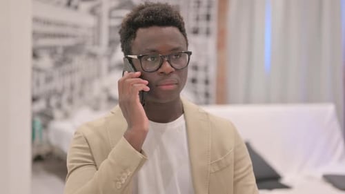 Young Adult Talking on Phone Indoors