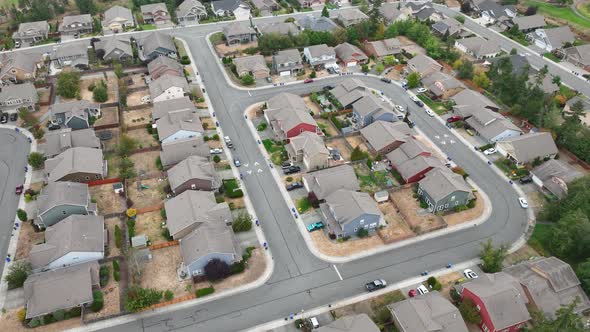 Aerial of a neighborhood community during the summer with burnt lawns ...