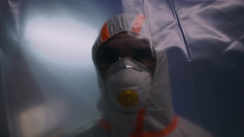 Female doctor in protective suit and mask working inside hospital during coronavirus pandemic