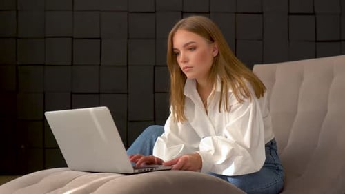 Young Woman Working on Laptop Indoors