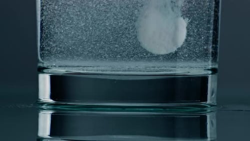 Effervescent Tablet Dissolving in Glass of Water