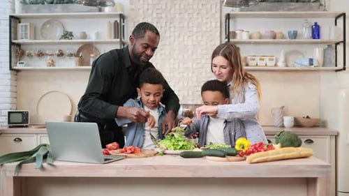 Mom and Dad Sharing Salad Recipe Multiracial Family Chatting Enjoying Time in Kitchen