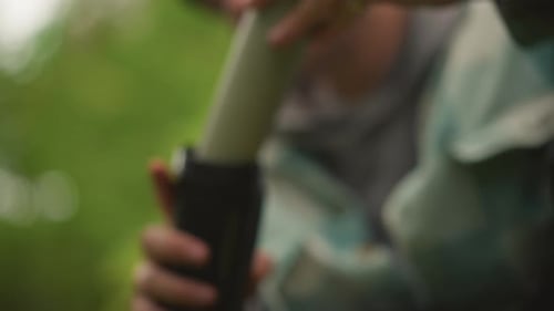 Man Packing Photography Equipment in Nature Environment