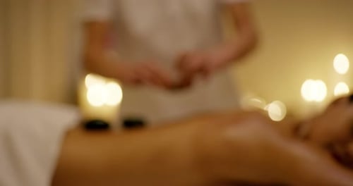 Woman Receives Relaxing Stone Massage at Spa