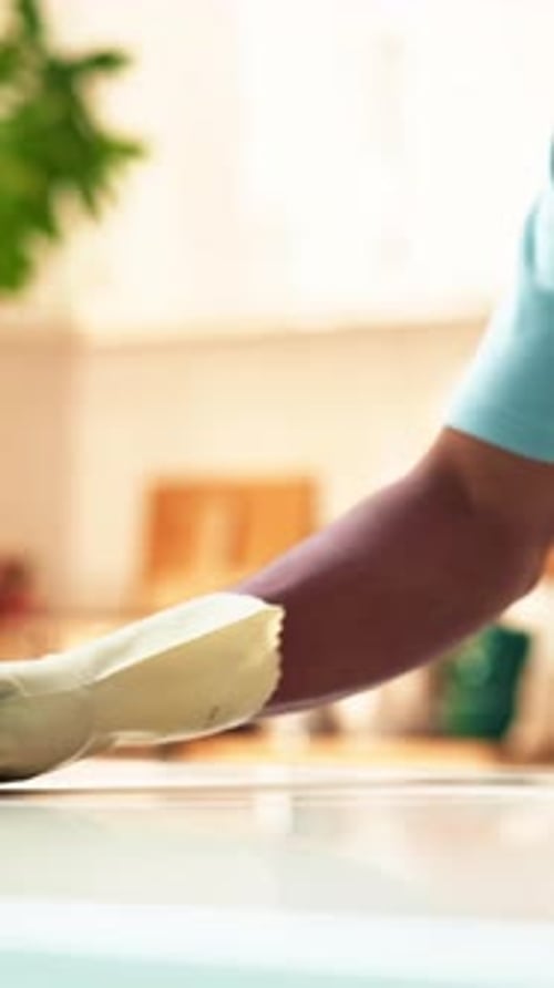Arm Wiping Kitchen Surface with Cleaning Cloth