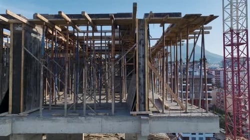 Aerial Video Construction Workers Install Steel Frames and Build New Walls Shaping the Last Floor