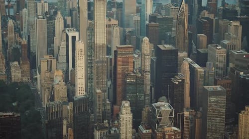 Majestic aerial view of New York City skyscrapers, buildings, streets and central park at sunset.