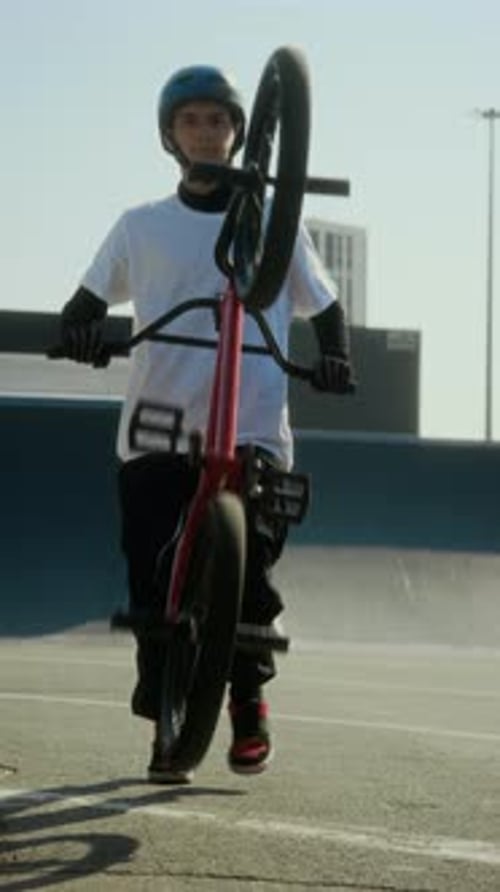 Young BMX Rider Practicing Manual Trick at Skate Park