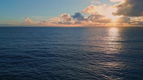 Rippling ocean surface reflecting bright golden sunset rays breathtaking marine sunrise