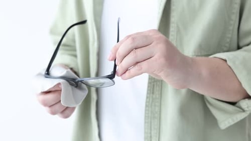 Man Cleaning His Glasses with a Cleaning Cloth