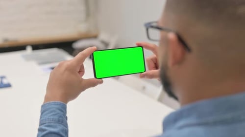 African Man Holding Phone Horizontal with Green Screen