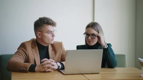 Coworkers Discuss Chart Graphics in Office Watching Report on Laptop Display Brainstorming