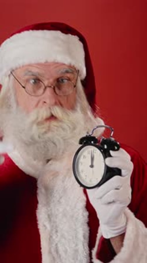 Santa Claus Holding Alarm Clock in Close Up