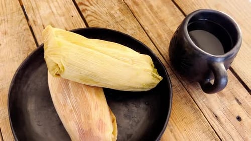 Tamales with Coffee on a Rustic Wooden Table