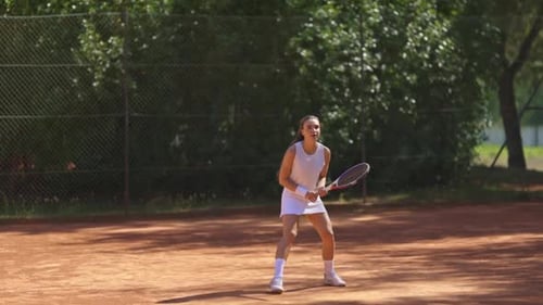 A Woman is Playing Tennis on a Court