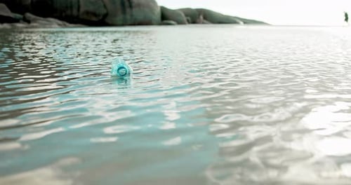 Water pollution, garbage and plastic bottle litter at beach for poor waste management
